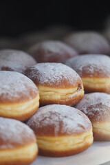 Freshly baked donuts dusted with powdered sugar displayed