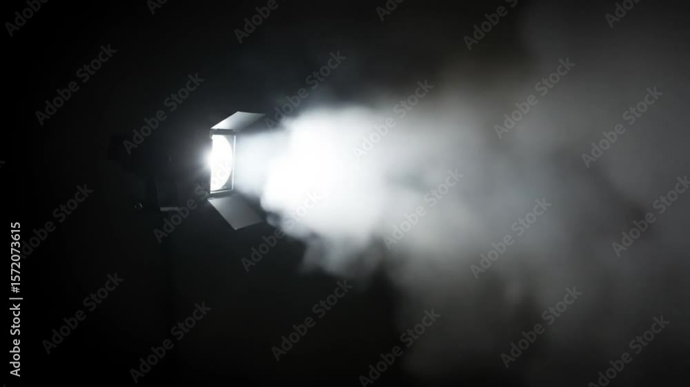 Poster a bright light source illuminates a cloud of smoke in a dark room creating a mysterious atmosphere