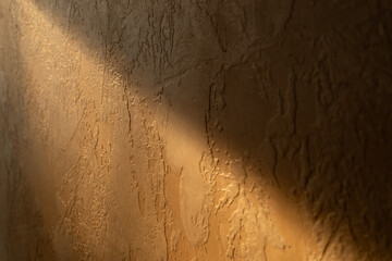 Rustic Plaster Wall with Sunlight and Shadow Casting Dramatic Textures