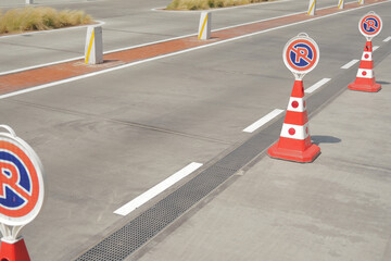 Road safety cones mark construction zone near pavement