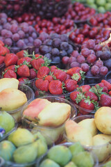 Fresh fruits displayed at a busy market in summer