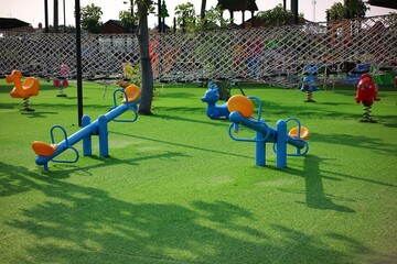 Outdoor Playground Featuring Seesaws, Spring Riders, and Play Area Equipment