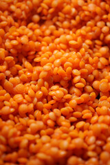 Vibrant orange lentils waiting for preparation in a bowl
