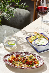 Haloumi cheese with tomato salsa in bright, rustic lighting, overhead tabletop composition