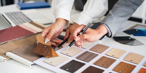 Close up of Female interior designer teamwork selects new painting colors and finishing material ,...