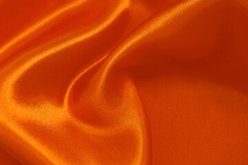 Orange fabric cloth texture for background and design art work, beautiful crumpled pattern of silk or linen.