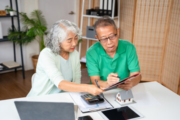Retirement, senior couple and ecommerce on laptop for home purchase finance decision together....
