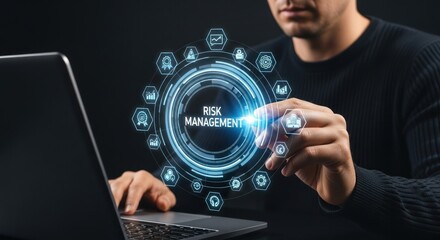 Man interacting with risk management interface on laptop in a dark setting with graphic elements