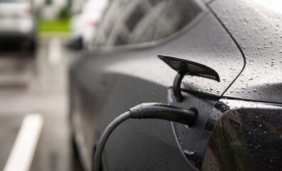 Electric battery car charge at EV station. concept of EV car and home charging station. Electric...