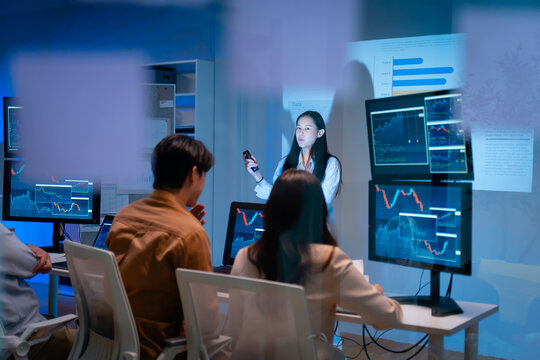 group of Happy young asian business people chatting happily after a night of overtime work in the office.Supervisor chats with employees after working together planning success strategy enjoy teamwork