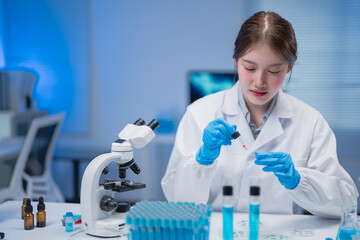 Young scientist in a lab coat performing research with a microscope and pipette. Laboratory setting includes test tubes and scientific equipment, highlighting the process of scientific discovery