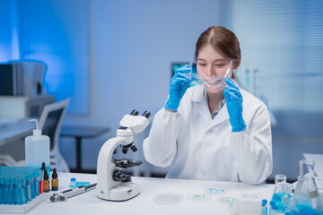 Young scientist wearing blue gloves and a protective face shield, conducting research in a laboratory filled with microscopes and petri dishes, focusing on innovative experiments