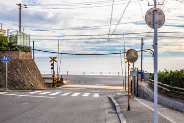 The Enoden Line with the sea as a background at Kamakura Kokomae station, one of the scenes in the...