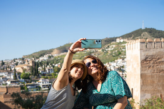 Tourists taking selfie in  granada, spain with smartphone