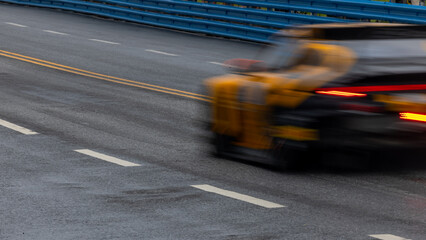 Motion blur race car racing on speed track, Motion blurred super car race on street track circuit,...