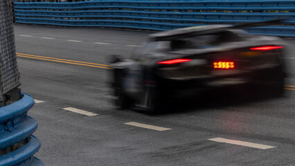 Motion blur race car racing on speed track, Motion blurred super car race on street track circuit,...