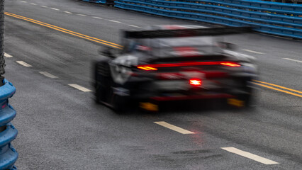 Motion blur race car racing on speed track, Motion blurred super car race on street track circuit,...