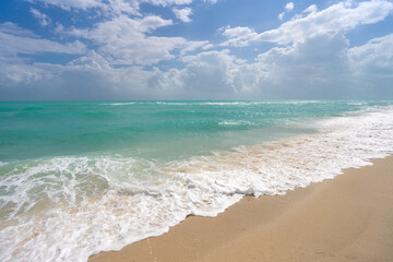 Turquoise sea water wave motion. Summer beach. Calm sea. Luxury seaside resort. Bright sky and...