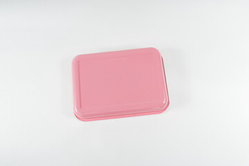 Plastic and stainless lunch box, which is black and pink in color. n white background, food...