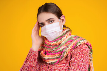 Woman wearing a mask during the flu epidemic. Young girl with a fever feeling unwell. Girl in a...