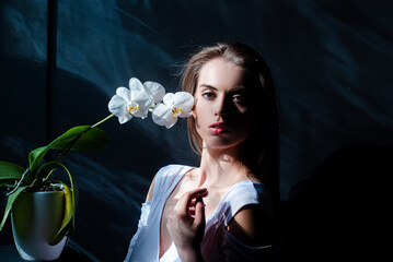 Sensual model portrait. Sexy portrait of tender beauty woman with orchid. Passionate model. Sensual...