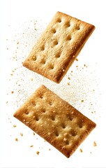 Two light brown crackers, rectangular shape, in mid-air, against a white background with scattered crumbs