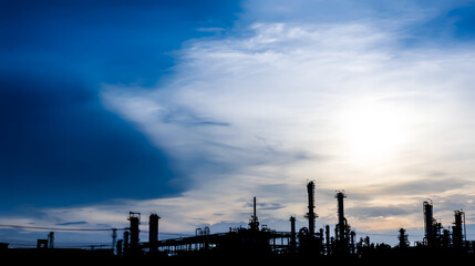 Obraz premium Abstract refinery silhouette with geometric shapes against gradient sky, symbolizing industrial innovation and modern energy production