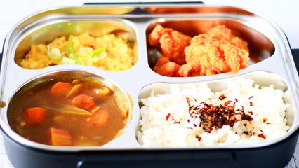 Bring packed lunch. Rice topped with nori, Japanese curry, karage and fried scrambled eggs.      