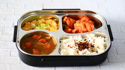 Bring packed lunch. Rice topped with nori, Japanese curry, karage and fried scrambled eggs.      