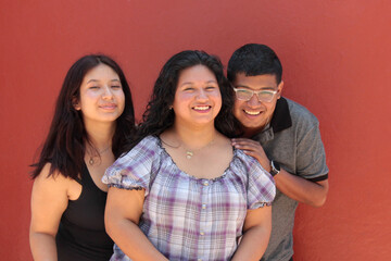 A group of young, dark-skinned Latino friends and family enjoy their time together, show their...