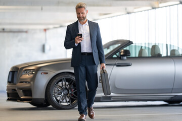 Business man outdoors. Rich business man enjoying success. Luxury businessman in elegant suit. Rich man front of expensive car. Luxury business travel. Confident rich business man in a classic suit.