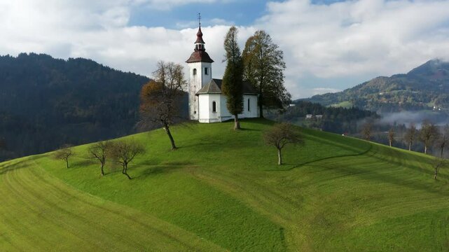 St. Thomas Church Over Hilltop In Skofja Loka, Slovenia. Aerial Drone Shot