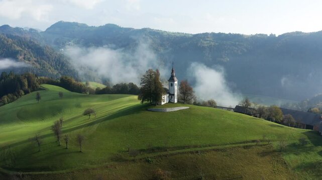 Picturesque Hilltop Church Of St. Thomas In Skofja Loka, Slovenia. Aerial Drone Shot