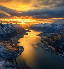 Golden Sunlight bathes a fjord, reflecting on water between snow-capped mountains in Norway.