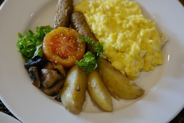 Breakfast Plate with Omelette, Sausages, Tomato, and Herbed Potatoes
