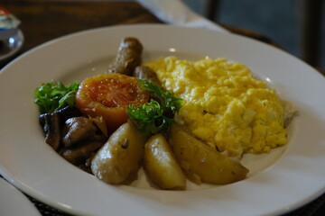 Breakfast Plate with Omelette, Sausages, Tomato, and Herbed Potatoes