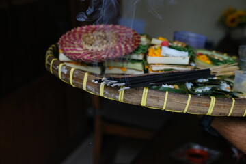 Smoking Incense Sticks on Traditional Balinese Offering Tray