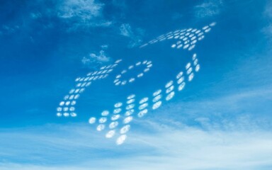 Flat design showing cloud letters FOOD is floating across blue sky with wispy cirrus