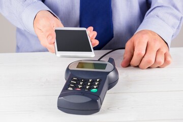 Man using smartphone to express pay