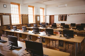 Flat design computer classroom is showing wooden desks with monitors, keyboards and sash windows