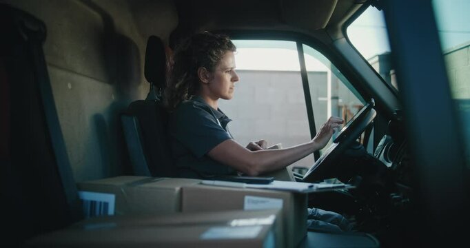 Female Delivery Truck Driver in Car Using Tablet Computer, Filling Out Papers, Delivering Cardboard Boxes with Online Orders, Purchases, E-Commerce Goods. Woman Working in Express Delivery Service.