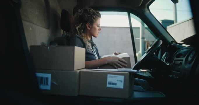Female Product Supplier in Truck with Cardboard Boxes Using Tablet Computer, Filling Out Papers. Female Courier Working in Express Delivery Service, Delivering with Online Orders, E-Commerce Goods.