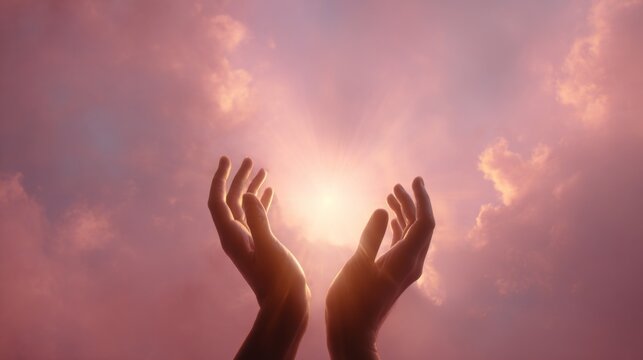 Hands reaching towards glowing light in pink cloudy sky, symbolizing hope and positivity  