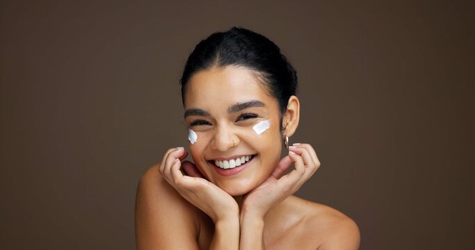 Beauty, portrait and girl with face cream in studio for collagen treatment, hydration and self care. Mockup, woman and happy with cosmetics product on brown background for skin glow and anti ageing