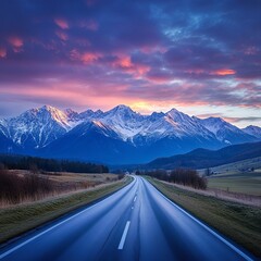 Fototapeta premium Panorama view of the High Tatra mountains with mount Krivan and a local highway in Slovakia at sunset