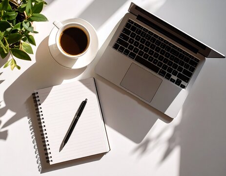 Top view of a minimalist desk with laptop, notebook, pen, and coffee cup, even soft daylight, flat lay composition