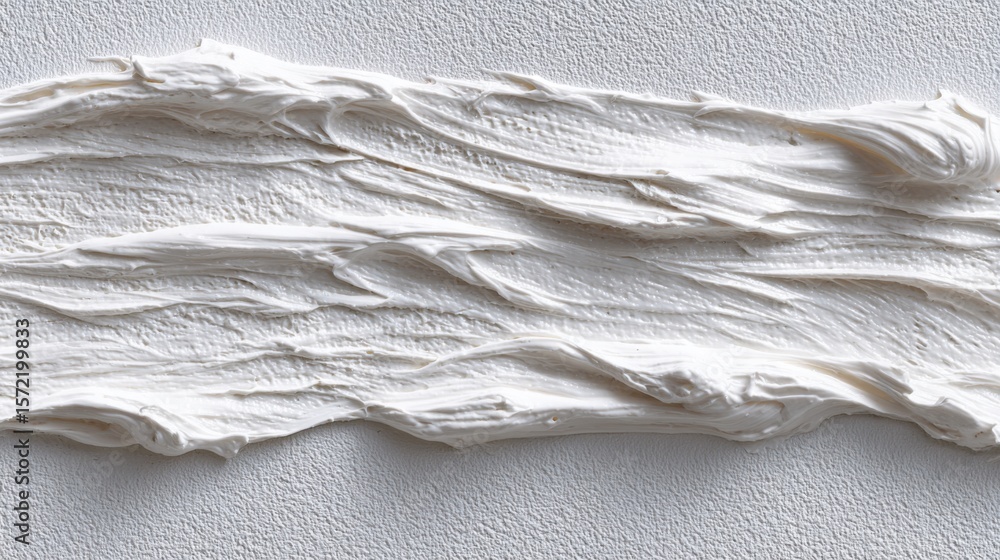 Poster a thick layer of white material is spread across a textured surface, showcasing the art of mixing an