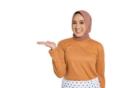 Smiling Muslim woman in hijab showing open palm to the side isolated on transparent background