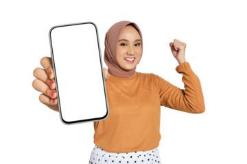 Excited woman wearing hijab holding blank smartphone screen and making fist gesture isolated on transparent background