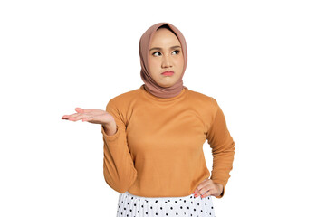 Unimpressed young Muslim woman in hijab raising hand with annoyed expression isolated on...